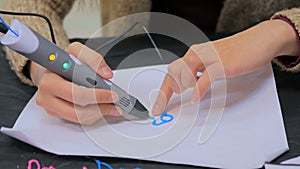 Woman using 3D printing pen