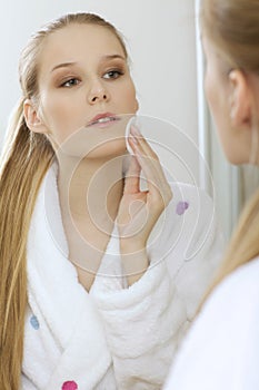 Woman using dabber, portrait, close-up