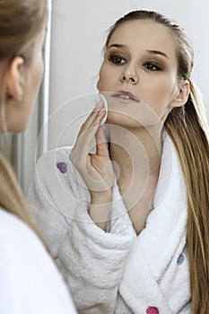 Woman using dabber, portrait, close-up