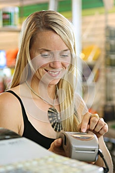 Woman using debit terminal