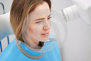 Woman using dental scanning machine in stomatology clinic