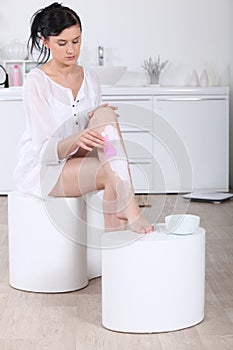 Woman using a depilatory cream