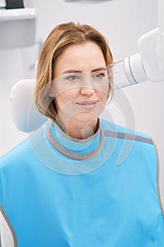 Woman using diagnostic equipment in dental clinic