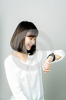 Woman using a digital clock in the display and technology advances in communication.