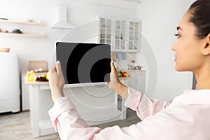 Woman using digital tablet with blank empty screen, mockup