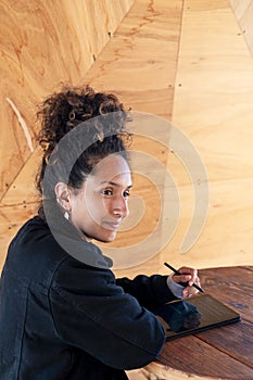 Woman using a digital tablet with an electronic pen.
