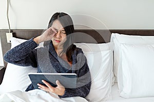 Woman using digital tablet and feeling eye pain