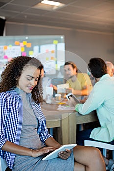 Woman using digital tablet at office