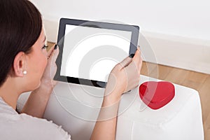 Woman using digital tablet for online dating