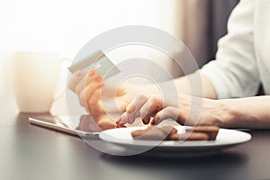 woman using digital tablet to make a payment