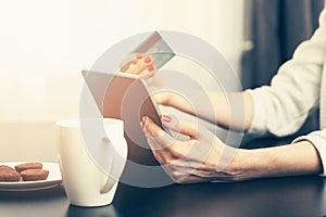 Woman using digital tablet to make a payment