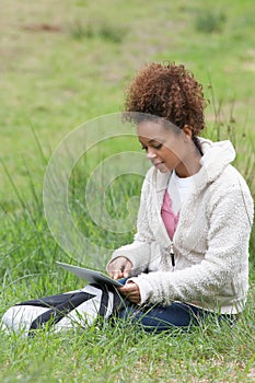 Woman Using Digital Tablet Whilst Hiking In Countryside