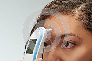 Woman using digital thermometer