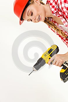 Woman using drill on ladder