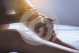 Woman using elastic bandage with legs having knee or leg pain,Female feeling exhausted and painful,Close up