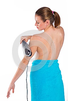 Woman using electric massager photo