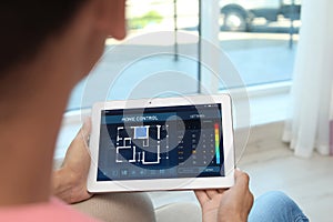 Woman using energy efficiency home control system on tablet