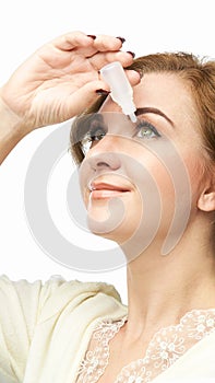 Woman using eye drops. Medicine treatment. Eyecare human problem. Ophtalmology