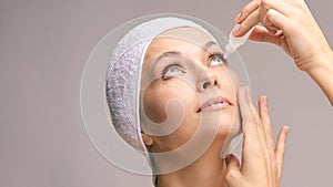 Woman using eye drops. Medicine treatment. Eyecare human problem. Ophtalmology dropper photo