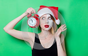 Woman using eye patch for her eyes in Santa Claus hat