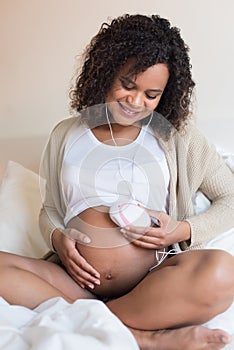 Woman using a fetal doppler at home
