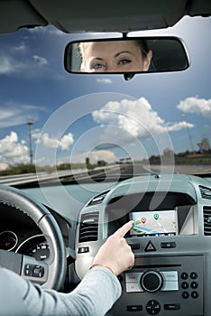 Woman using gps navigator in a car