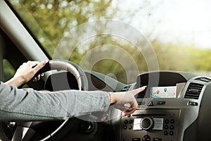 Woman using gps navigator in a car
