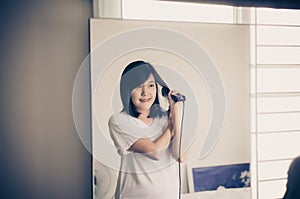 Woman using hair irons with straightening