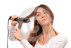 Woman using hair straighteners for hairstyle