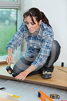 Woman using hammer and chisel