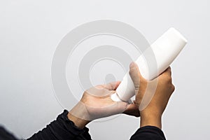 A woman using hand and body lotion