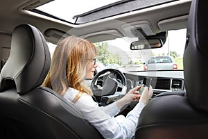 Woman using handy in her car