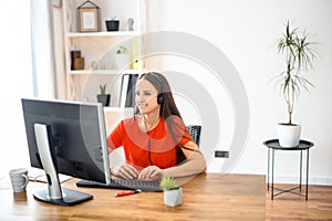 Woman using headset and pc for work