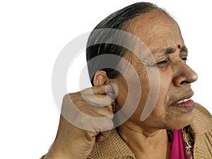 Woman using her finger to scratch ear due to ear pain or earache on white background isolated