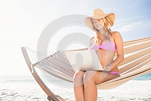 Woman using her laptop in hammock