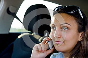 Woman using her mobile in a car