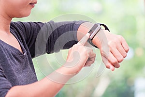 Woman using her smart watch at home