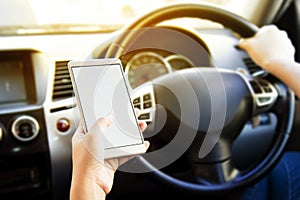 Woman using her smartphone open mobile application navigation or gps while driving. Blurred car interior background. Viewing