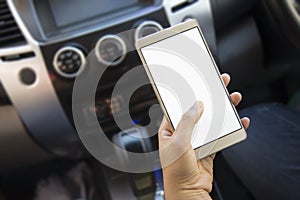 Woman using her smartphone open mobile application navigation or gps while driving. Blurred car interior background. Viewing