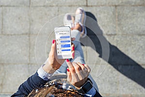 Woman using instant messaging app on mobile phone photo