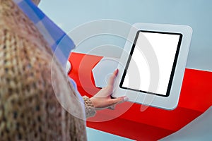 Woman using interactive empty white touchscreen display kiosk at exhibition