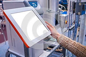 Woman using interactive empty white touchscreen display kiosk at exhibition