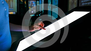 Woman using interactive empty white touchscreen display