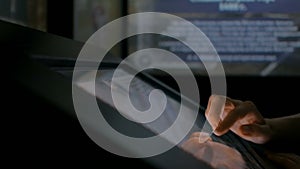 Woman using interactive touchscreen display at modern history museum