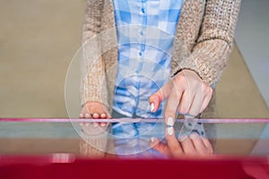 Woman using interactive touchscreen display at modern museum or exhibition