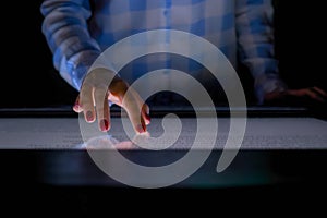 Woman using interactive touchscreen display at modern museum or exhibition