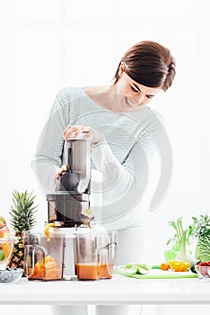 Woman using a juice extractor