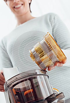 Woman using a juice extractor