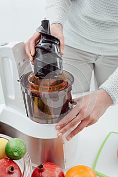 Woman using a juice extractor