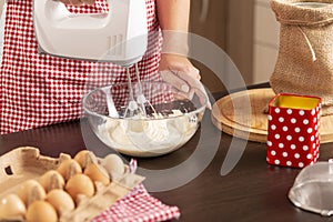 Woman using kitchen mixer